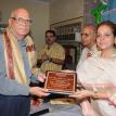 Dr.Mohan Kalani recieving the Life Time Achivement Award from Ms.Anila Sunder